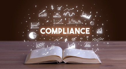 COMPLIANCE inscription coming out from an open book, business concept