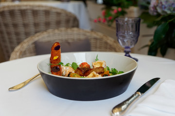 Starter of fried duck liver, camembert and lettuce served outdoors