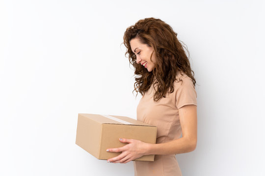 Young pretty woman over isolated background holding a box to move it to another site