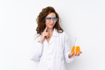 Young pretty woman over isolated background with a scientific test tube