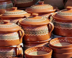 A group of clay pottery, hand made dishes