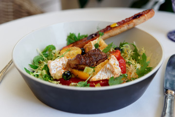 Starter of fried duck liver, camembert and lettuce