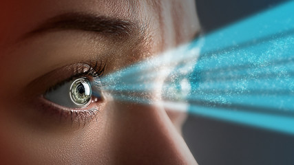 Female eye close up with smart contact lens with digital and biometric implants to scanning the...