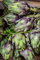 A full frame photograph of globe artichokes for sale on a market stall