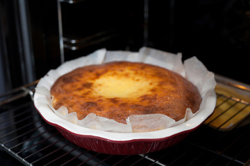 Oven baked cottage cheese casserole. In red baking dish.
