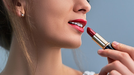 Stylish sensual beautiful woman model with bright red lipstick and red lips. Cosmetics and makeup