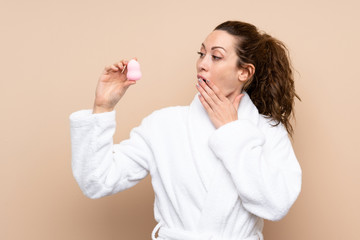 Young woman in a bathrobe over isolated background