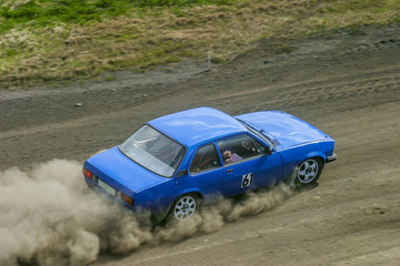 Fototapeta na wymiar Rally car drives on a gravel road