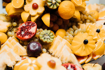 Beautiful wedding candy bar with a lot of sweets, fruits and food. Wedding banquet table