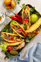 Corn tortilla tacos with grilled chicken meat and fresh vegetables, close up, top view. Traditional Mexican dish
