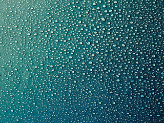 Water drops on turquoise background.