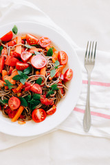 delicious Italian pasta with tomatoes, carrots and Basil on a white napkin