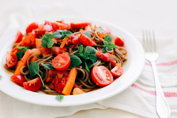 delicious Italian pasta with tomatoes, carrots and Basil on a white napkin