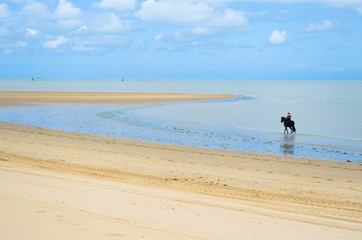 Horseback riding along the riverbank of the Guadalquivir River in Sanlúcar de Barrameda,...