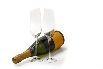 Beautiful view champagne bottle and  two  slim, tall and elegant champagne glasses on white background. Beautiful backgrounds. Alcohol concept. 