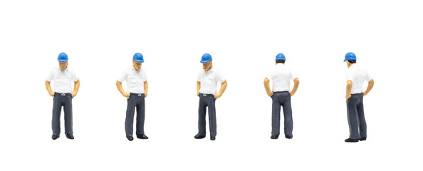 Fototapeta na wymiar Miniature figurine character as worker wearing safety vest and posing in posture isolated on white background.