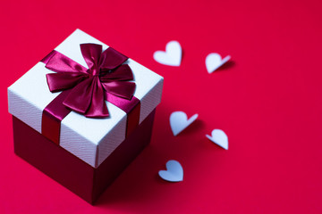 Gift boxes and hearts on a red background