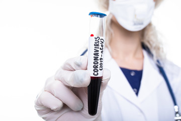 The girl doctor holds a test tube with blood in which the coronavirus was found