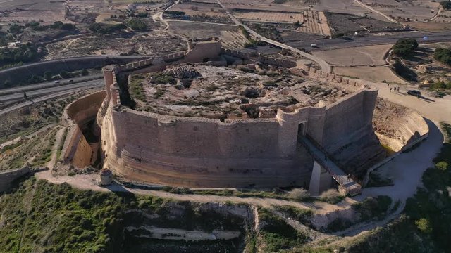Aerial view of Chinchilla de Montearagon castle with ruined excavated inner building remains surrounded by an outer wall with semi circular towers