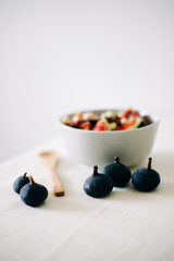 healthy Breakfast oatmeal with figs and cashews on a white table. vegan food