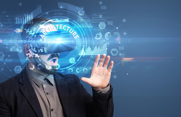 Fototapeta premium Businessman looking through Virtual Reality glasses with ARCHITECTURE inscription, innovative technology concept