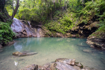Naklejka na ściany i meble Hidden in jungles Ingkumhan waterfalls, popular tourist attraction in Dimiao, Bohol, Philippines