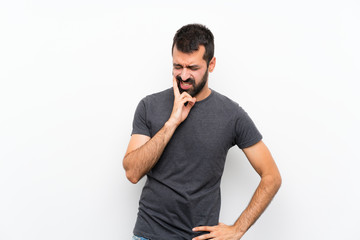 Young handsome man over isolated white background with toothache