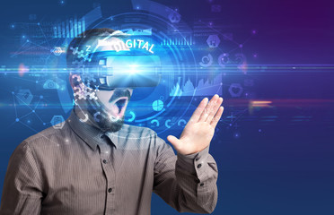 Businessman looking through Virtual Reality glasses with DIGITAL inscription, innovative technology concept