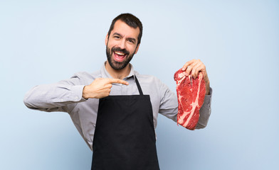 Chef holding a raw meat holding copyspace imaginary on the palm to insert an ad
