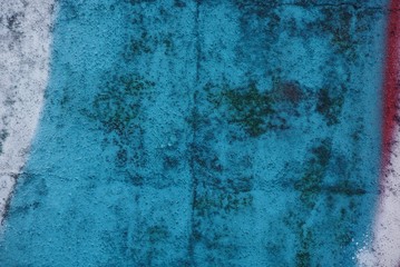 blue white texture of colored paint on a dirty concrete fence wall