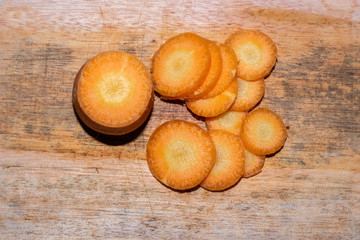Chopped carrot slices , isolated with a blue background