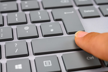 Finger pressing the shift key close up