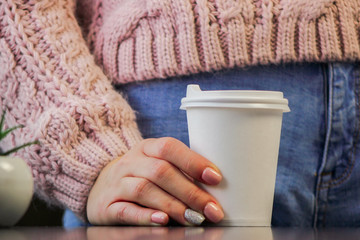 hands holding a cup of coffee