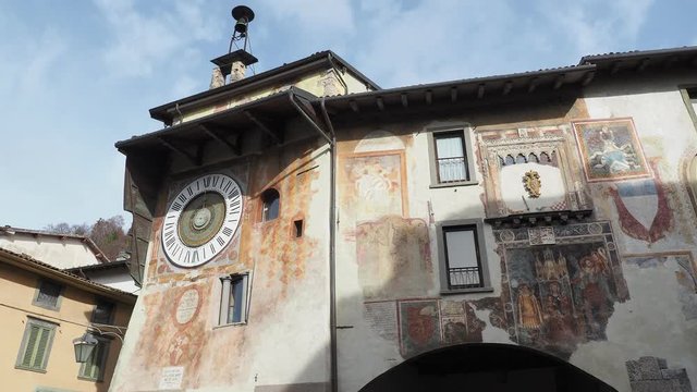Clusone, Bergamo, Italy. The astronomical or planetary clock and the facade of the town hall. Famous attraction of the city. It has been loaded by hand every day for about four hundred years