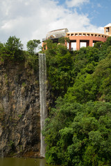 Fototapeta na wymiar Quarry view with waterfall and vegetation