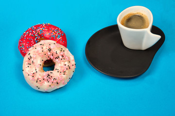 doughnuts and a Cup of coffee on a blue background, space for text
