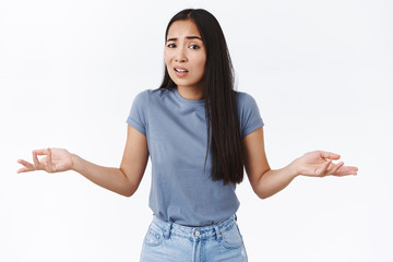 Asian girl didnt understood whats going on, standing perplexed, what you want from me pose,...