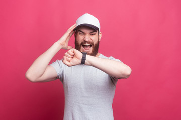 photo of young man looking afraid at watch