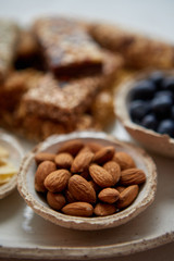 Close up of whole Almonds. With various energy nutrition bars in background