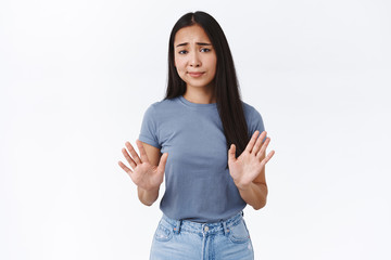 Skeptical, arrogant and unamused asian woman, raising arms in stop, refusal motion, smirk and...
