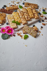 Fototapeta na wymiar Various kinds of protein granola bars with dry fruits and berries