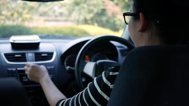 Woman Turning Button Of Radio In Car Stock Photo - Download Image