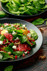 Orange Grapefruit salad with spinach, walnuts, pomegranate seeds and feta cheese. healthy food