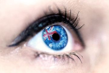 Flag of Australia reflects in a woman blue eye - election, sport, hope, young, generation, pride,...