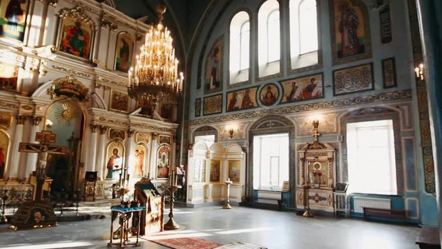 Panoramic inside catholic church showing the ceiling and altar with sacred images