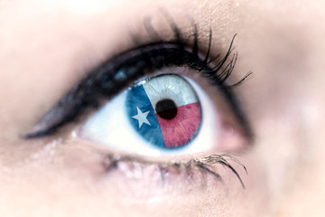 Flag of Texas state of the United States of America reflects in a woman blue eye - election, sport, hope, young, generation, american football, basket, emotion