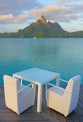 Naklejka na ściany i meble Table and chairs with a view of the Mont Otemanu and the Bora Bora lagoon in French Polynesia