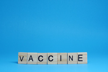 Vaccine Virus Corona - Wood object word on Blue Background and copy space - Prevent epidemic Virus outbreak Concept 