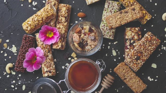 Healthy superfood composition. Various kinds granola energy protein bars with honey in jar