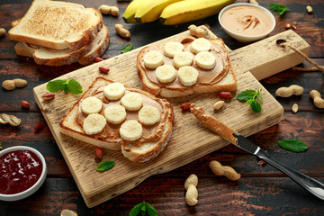 Peanut Butter and banana Sandwich on wooden board. morning breakfast